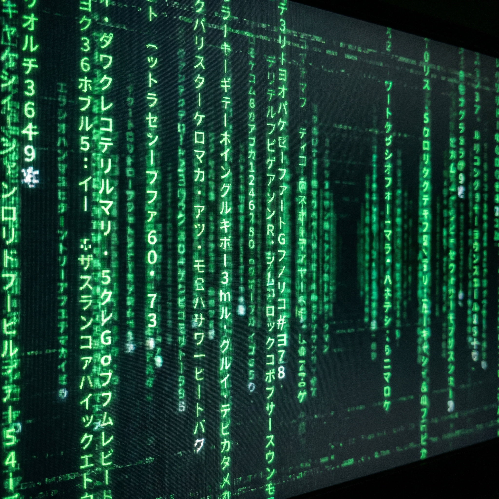 Matrix digital rain effect: glowing green characters cascading vertically, sharp foreground fading to blurred mid-ground and luminous background, neon green phosphor glow against pure black, cinematic tech aesthetic
